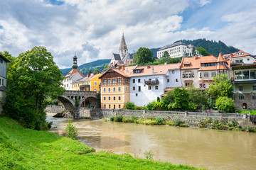 Naklejka premium View of the town of Murau in state Steiermark, Austria. Scenic arch bridge over river Mur.