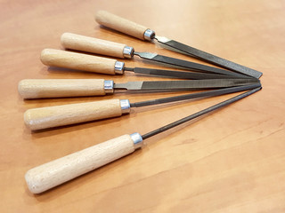 Close up shot of warding file assortment on a wooden table