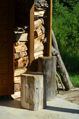 Cut logs of wood, cut wood pile of firewood behind