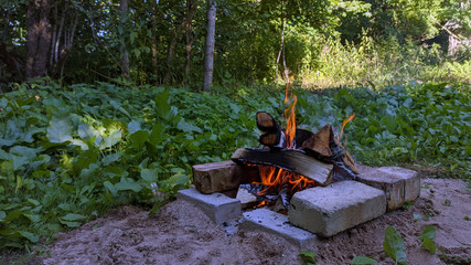 Camp fire in the night. Bonfire.  Flame and fire sparks on dark background.  Black copy space.