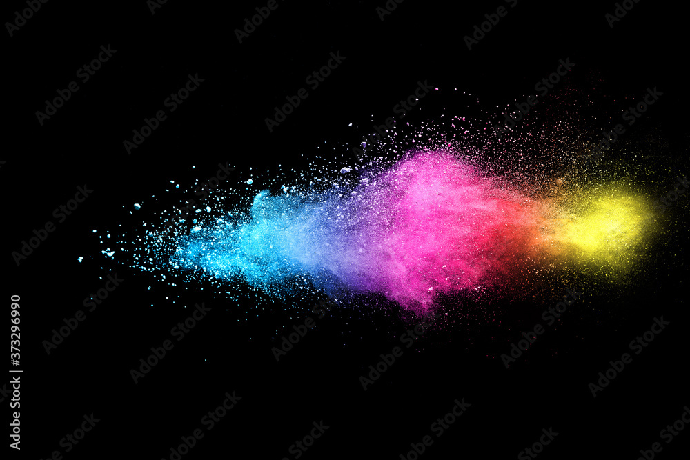 Wall mural Explosion of colored powder isolated on black background. 