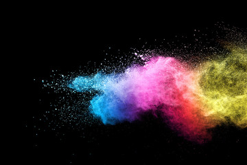 Explosion of colored powder isolated on black background. 