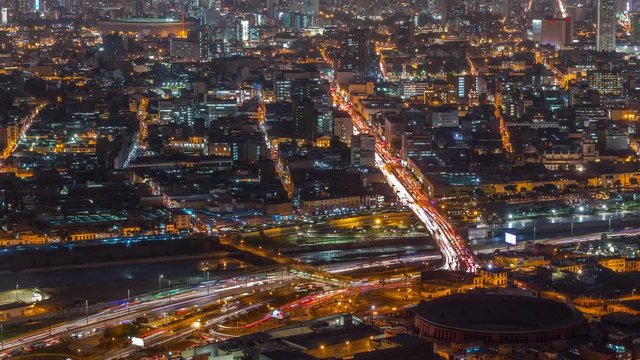 Aerial view of Lima skyline day to night transition timelapse from San Cristobal hill with Plaza de Toros de Acho bullring. Traffic on bridges and Rimac river. Landscape of slum urban area and