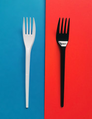 black and white forks on red and blue background