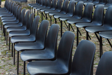 Black chairs in row outside