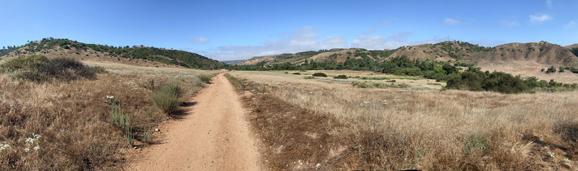 Fototapeta na wymiar Panoramic view of dry dusty trails in the valley with blue sky, San Diego, California, USA