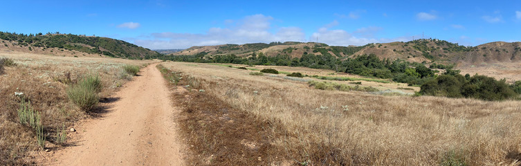 Fototapeta na wymiar Panoramic view of dry dusty trails in the valley with blue sky, San Diego, California, USA