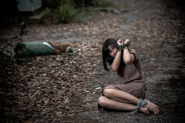 Asian hostage woman Bound with rope at night scene,The thieves kidnapped for ransom,thailand people