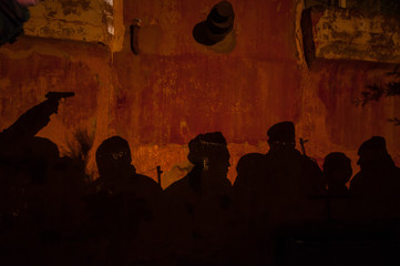 Shadow of soldiers on wall at night. Army concept. Fighting silhouettes on colored stone wall