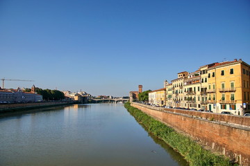 Fototapeta na wymiar River Arno passing through the historic center of Pisa in Pisa, Italy