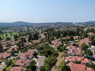 Fototapeta na wymiar Aerial view of middle class neighborhood with residential house community and mountain on the background in Rancho Bernardo, South California, USA.