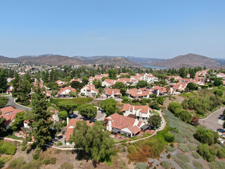 Fototapeta na wymiar Aerial view of middle class neighborhood with residential house community and mountain on the background in Rancho Bernardo, South California, USA.