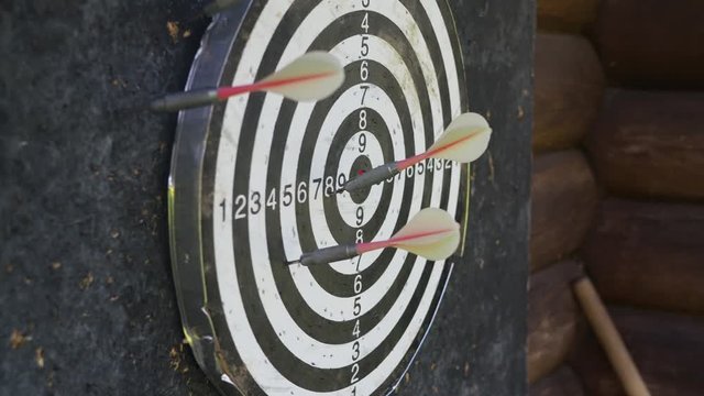 Throwing darts arrows at the target and hitting random points.