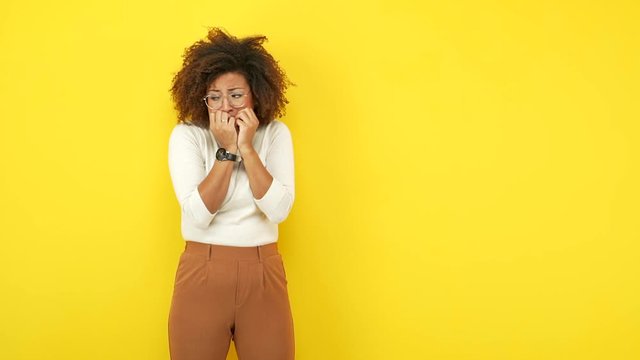 Young african american woman biting nails, nervous and very anxious 