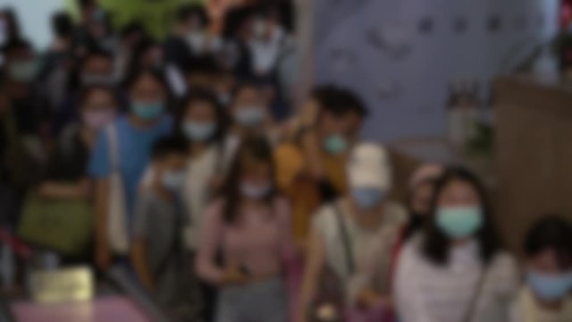 4K, Blurred defocused view of crowd people wearing surgical mask in escalator of subway. Coronavirus pneumonia has been spreading into many cities. 2019-nCoV epidemic China.-Dan