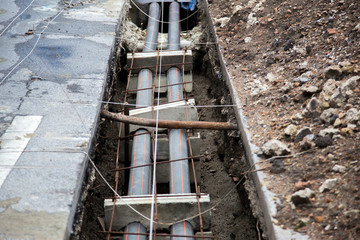 electric fiber underground of street in construction process urban