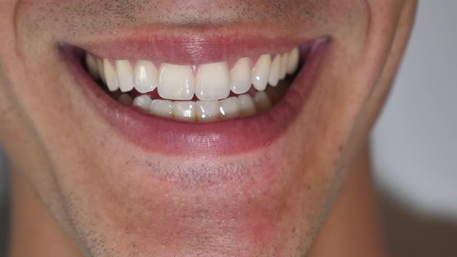 Clean Shaven Male Extreme Close Up of Straight White Teeth Mouth Licking Lips and Smiling to Camera