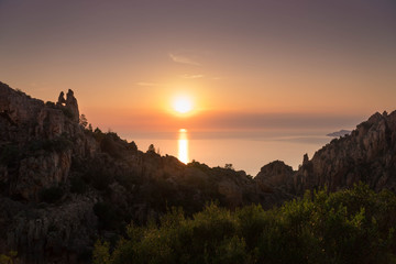 Les Calanques de Piana (Corsica) during sunset with heart-shaped hole in rocks