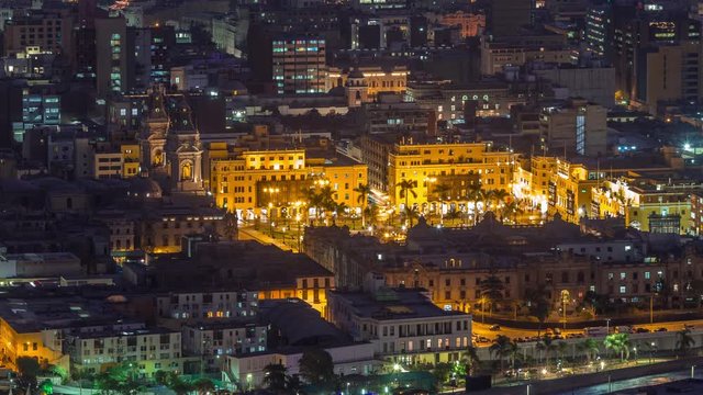 Aerial top view of Lima main square from San Cristobal hill day to night transition timelapse, government palace of Peru and cathedral church. People gathered at Plaza de Armas in the historic center