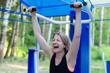 Fototapeta premium Happy woman on a simulator in the park