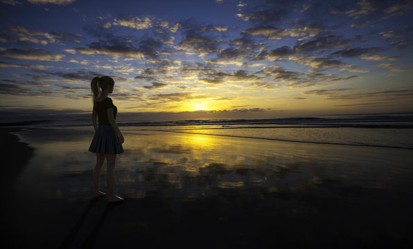 3D render entitled Looking at sunset. Person in the image is computer generated by 3D rendering. No model release is needed as the person is fictitious.'