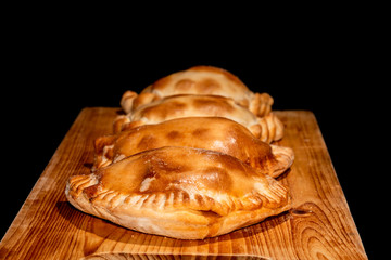 Freshly cooked empanadas with black background