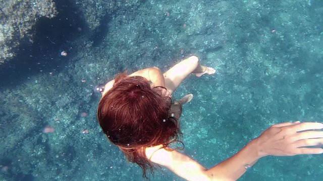 woman diving in mediterranean sea under the water