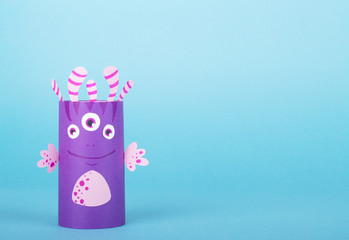 Paper monsters on a blue background. Handmade concept, creative idea from toilet tube