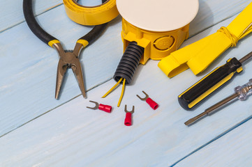 Yellow spare parts and tool on blue boards for electrical prepared before repair or setting