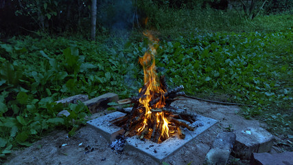 Camp fire in the night. Bonfire.  Flame and fire sparks on dark background.  Black copy space.