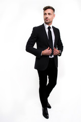 Perfect style. Full length of handsome young man looking away while standing against white background

