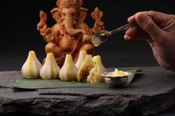 Modak- a traditional dish made on Ganpati festival in India. served with clarified butter. Ganesh...