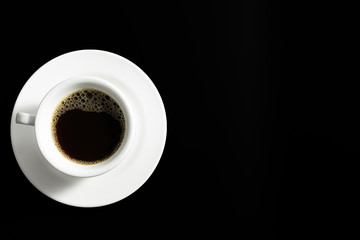hot black coffee in white coffee cup and saucer on black background.top view,top down,flat lay.