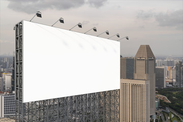 Obraz premium Blank white road billboard with Singapore cityscape background at sunset. Street advertising poster, mock up, 3D rendering. Side view. The concept of marketing communication to sell idea.