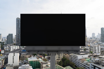 Blank black road billboard with Bangkok cityscape background at day time. Street advertising poster, mock up, 3D rendering. Front view. The concept of marketing communication to promote or sell idea.