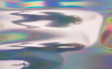 Abstract background of holographic strings of all rainbow colors. Scratched holo foil surface.
