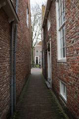 Fototapeta na wymiar Traditional Dutch Houses in an Alley in Veere, Zeeland, Netherlands
