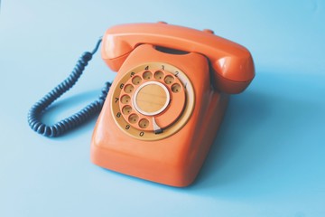 Vintage telephone over blue background.