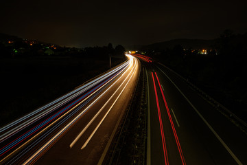 Fototapeta na wymiar Red white blue car light trails on a road highway