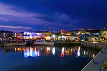 Fototapeta na wymiar The Knysna Waterfront at Dusk, South Africa. Knysna is a town in the Western Cape Province of South Africa and is part of the Garden Route. The town is a popular destination for senior citizens 