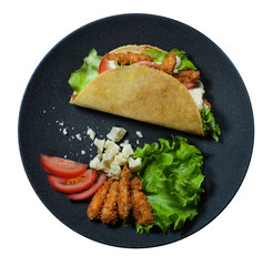 Top view taco with with fried chicken meat and vegetables, parmesan and ingredients on the black plate isolated