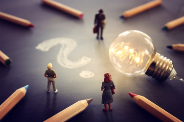 Surreal image of people looking at glowing light bulbs. Concept of finding the right idea, or solution