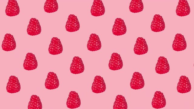 pattern with many fresh ripe raspberry animated on a pink background close-up. seamless looping of realistic 3d food. minimal stop motion design art with copy space for text
