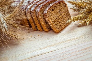 Freshly baked bread. Fresh loaf of rustic traditional bread with wheat grain ear or spike plant on...