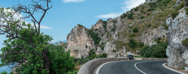 Evocative view of the Amalfi coast road. Motorcyclists observe the landscape. © iannonegerardo69