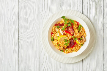 spanish chicken paella on a white plate