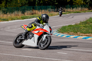 Fototapeta premium Motorcycle practice leaning into a fast corner on track