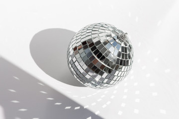 Fototapeta na wymiar Shining disco ball on white background. Disco ball with bright rays