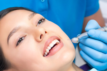 Young Female patient with pretty smile examining dental inspection at dentist clinic. Healthy teeth and medicine, stomatology concept