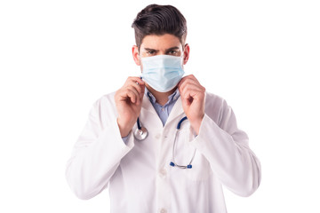 Shot of male doctor wearing face mask while standing at isolated white background